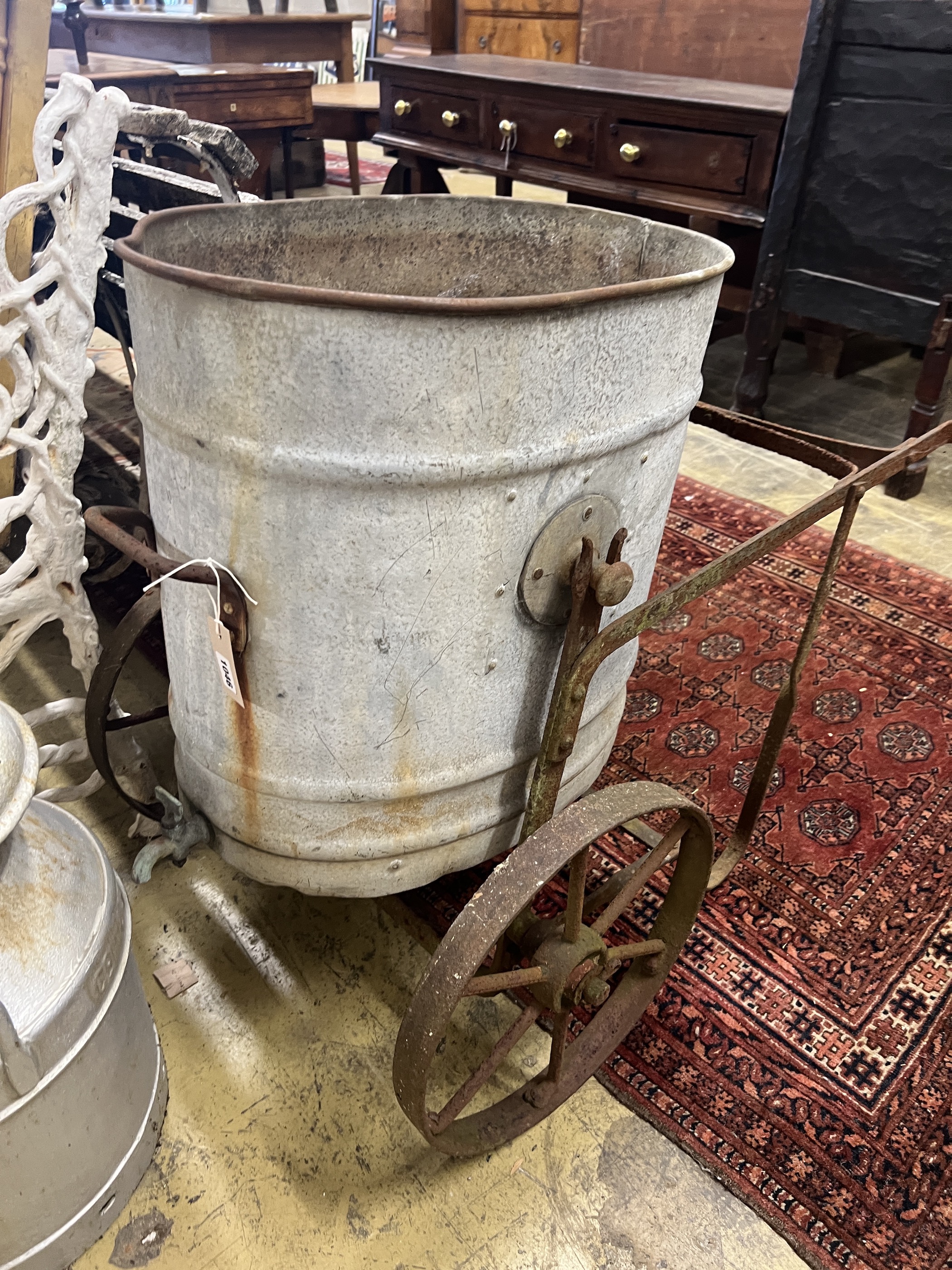 A Victorian galvanised and wrought iron water barrow, height 73cm together with a churn